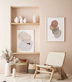 a living room with pink walls and wooden shelves filled with vases, plants and pictures