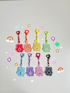 there are many bear key chains hanging on the refrigerator door and it is decorated with rainbow colors