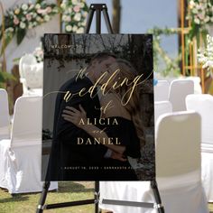 an easel with a wedding photo on it and the words welcome to us in gold foil