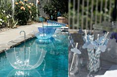 there are several glass vases with umbrellas in them next to a pool and fence