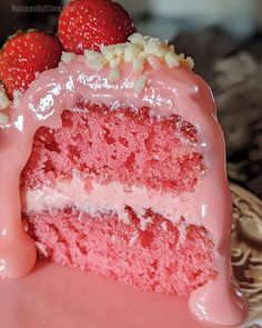 a slice of strawberry cake with icing and strawberries on top