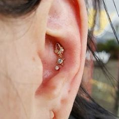 a close up of a person's ear with an ear piercing