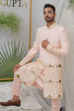 Soft pink sherwani with gold acrylic elephant, khidki motifs and pipe embellishment. Paired with kurta and pant pyjama.
Components:3
Pattern:Embroidery
Type of Work:Elephant, khidki, pipe
Neckline:Mandarin collar
Sleeve Type:Full sleeves
Fabric:Chanderi Silk, Cotton
Color:Pink
Other Details:
Front button placket
Note: Dupatta worn by the model is not for sale
Occasion:Destination Wedding - Aza Fashions Embroidery Elephant, Pink Sherwani, Pattern Embroidery, Kurta With Pants, Pink Elephant, Silk Embroidery, Full Sleeves, Mandarin Collar, Aza Fashion