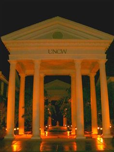 an illuminated building with columns and pillars at night