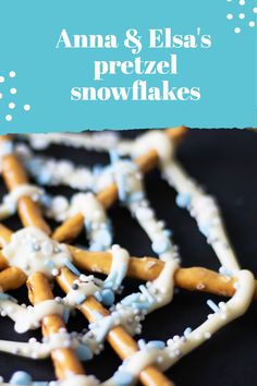 an image of some pretzel snowflakes on a black plate with blue and white frosting