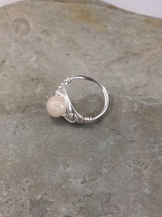 The tranquil beauty of this genuine rainbow moonstone ring is stunning. Moonstone has a soothing nurturing energy. It is the stone of the mother moon. The faceted cut of this gemstone is beautiful in its simplicity. I chose to enhance it with a Celtic inspired silver wire design to let the natural beauty of the moonstone shine. Pair this flattering ring with your favorite outfit, dressed up or down, the possibilities are endless! This ring is handmade by me with a genuine rainbow moonstone. The Adjustable Moonstone Rings With Natural Stones, Adjustable Moonstone Crystal Ring With Birthstone, Adjustable Moonstone Ring With Round Stone, Adjustable Fit Moonstone Ring With Round Stone, Minimalist Adjustable Moonstone Ring With Natural Stones, Adjustable Moonstone Promise Ring With Natural Stones, Adjustable Moonstone Ring For Healing, Adjustable Moonstone Healing Ring, Adjustable Spiritual Moonstone Ring