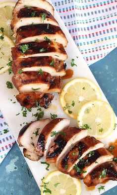 sliced chicken with lemons and parsley on a plate