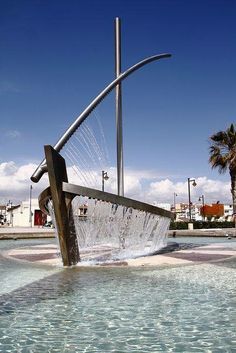 an artistic sculpture in the middle of a fountain