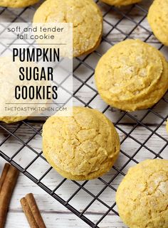 pumpkin sugar cookies on a cooling rack with cinnamon sticks