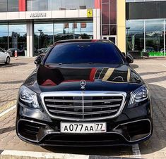 a black car parked in front of a building