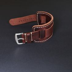 Bund strap of High quality. Leather watch band for men is durable, soft, elastic with a pleasant texture to the touch. It will surely serve you for many years. Compatible with watch case 18mm, 20mm, 22mm, 24mm.

The strap comes in two colors: brown, dark brown and gray with a green tint. The strap with a noble sheen and vintage effect will accentuate the beauty of your watch and make it stand out from everyone else.
Handmade leather cuff watch strap is unique. Due to the peculiarity of the leather from which the strap is made, there cannot be two such identical straps.

Leather bund band is made of the best Italian leather from the Badalassi Carlo factory. Vegetable tanned watch bund band, eco-friendly breathable. It has a pleasant smell of natural leather. The Bund, Military Design, Leather Watch Band, Cuff Watch, Colors Brown, Leather Watch Strap, Leather Watch Bands, Leather Cuffs, Watch Case