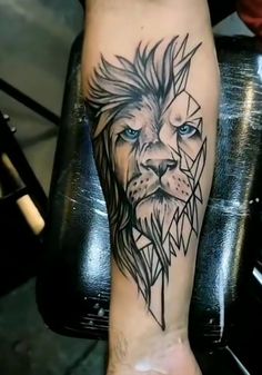 a tattoo on the leg of a person with a lion head and triangles around it