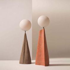 two orange and white lamps sitting next to each other