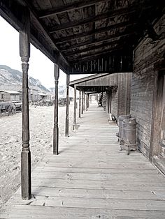 an old building with wooden pillars and benches