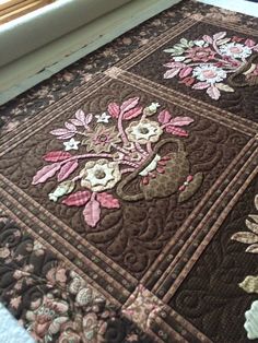 a close up of a quilt with flowers on it