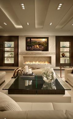 a living room filled with furniture and a fire place in the middle of the room