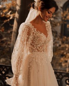 a woman in a wedding dress standing on a bench