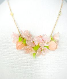 Embrace the beauty of blossoms with our Handmade Shrink Plastic Peach Flower Necklace! Carefully crafted, this stunning piece captures the essence of delicate peach blossoms in a wearable form. The lightweight and durable shrink plastic pendant ensure comfort, while the intricate details showcase the artistry behind each piece. Perfect for nature lovers and those who appreciate handmade jewelry, this unique necklace adds a touch of elegance to any outfit. Ideal as a thoughtful gift, this Peach Flower Necklace is a symbol of beauty and creativity, bringing the charm of spring wherever you go. Elevate your style with this handmade accessory, a true celebration of nature's grace and craftsmanship! Shrink Plastic Necklace, Delicate Spring Jewelry With 3d Flowers, Spring Feminine 3d Flowers Jewelry, Spring Flower Jewelry With 3d Flowers, Feminine Blossom Jewelry For Spring, Spring Wedding Jewelry With Petal Design, Feminine Petal-shaped Jewelry For Spring, Spring Flower Pendant Jewelry With Floral Decoration, Spring Flower Pendant Jewelry With Flower Decoration