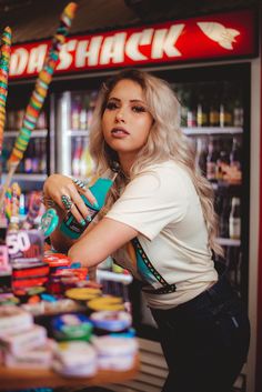 a woman standing in front of a candy store