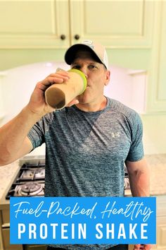 a man drinking from a cup in the kitchen with text overlay that reads fuel - packed, healthy protein shake