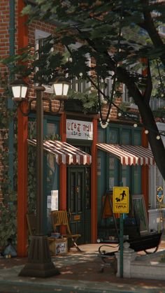 an empty street corner in front of a building with awnings and chairs on the sidewalk