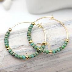 "Get ready to add a touch of bohemian charm to your jewelry collection with these 14k gold filled Bohemian hoop earrings featuring stunning turquoise colored seed beads. Handmade with care, these earrings are a unique and eye-catching addition to your wardrobe. The 14k gold filled material ensures that these earrings are durable and long-lasting, making them perfect for everyday wear. The turquoise colored beads add a pop of color and create a tribal look that's perfect for summer and beyond. Th Beaded Jewelry Earrings, Silver Threader Earrings, Boho Hoop Earrings, Sea Glass Earrings, Turquoise Boho, Homemade Jewelry, Earring Cards, Beads Handmade, Absolutely Fabulous