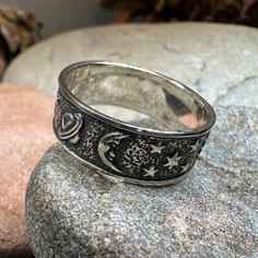 This Solid Sterling Silver Crescent Moon & Stars ring with an entire tiny universe on the band. The ring is adorned with an intricate celestial detail that goes all around the band - an artful rendition of the traditional design. Oxidized finish combines with polished detailing lets the tiny moons, stars, planets and sun stand out. Meticulously crafted from fine sterling silver with beautiful detailing, this Celtic Moon & Stars ring showcases the beauty of Celtic tradition, modern design, and fi Engraved Celestial Promise Ring Jewelry, Adjustable Celestial Engraved Jewelry, Symbolic Intricate Design Promise Ring, Symbolic Promise Ring With Intricate Design, Mystical Engraved Silver Rings, Mystical Moon Phase Ring For Anniversary, Vintage Silver Ring With Sun And Moon Design, Celestial Style Stackable Rings For Anniversary, Celestial Stackable Promise Rings