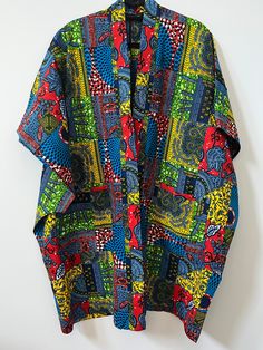 Up your style with this beautifully unique Kimono - they always make a statement! Crafted from African Wax Print fabric. Style with jeans, a skirt or dress. Open front Midi length Kimono style Relaxed, oversized fit Lightweight Short sleeves Patch front pockets 100% Cotton. One Size. Length = 38.5" Kimono Ankara Styles, Ankara Top Styles, Unique Kimono, Kimono Styles, African Print Kimono, Ankara Kimono, Moda Kimono, Black Superstar, Ankara Jackets