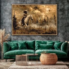 a living room with a green couch and a painting on the wall above it that has a cowboy riding a horse