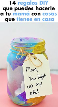 a jar filled with liquid sitting on top of a pink table next to a sign