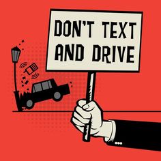 a hand holding a sign that says don't text and drive