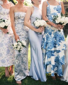 four bridesmaids in blue and white dresses standing together