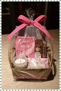 a basket with candles, soaps and other items in it sitting on a table