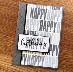 a birthday card with the word happy on it and some black and white paper in front