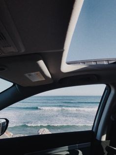 the view from inside a car looking out at the ocean