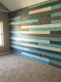 an empty room with wood planks painted on the wall and carpeted flooring