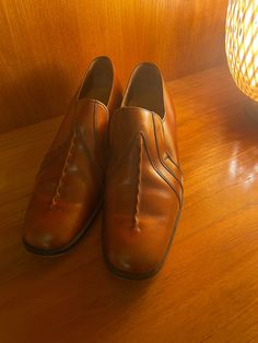 Super cool 70s vintage leather slip on shoes in rich honey tan leather with stack heel by K.  Excellent Vintage Condition  Size UK 8 Measurements  Full sole 11" 29cm Heel height 1 1/2" 3cm Vintage Almond Toe Loafers For Business, Retro Closed Toe Formal Loafers, Retro Loafers With Almond Toe And Leather Sole, Retro Formal Closed Toe Loafers, Retro Closed Toe Loafers For Formal Occasions, Vintage Slip-on Leather Shoes For Business, Retro Almond Toe Loafers With Leather Sole, Retro Slip-on Loafers For Formal Wear, Retro Formal Leather Shoes With Almond Toe