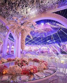 an elaborately decorated banquet hall with chandeliers and flowers