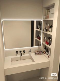 there is a bathroom sink and mirror in this room with shelves on the wall behind it