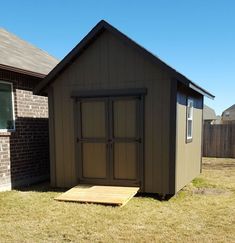 a small shed sitting in the middle of a yard