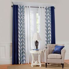 a living room with white walls and blue curtains