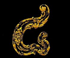 the letter s is made up of gold and black swirly designs on a black background