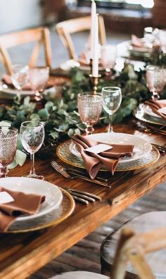 the table is set with plates and place settings