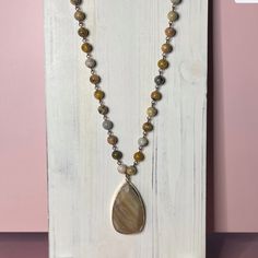 Beautiful Earthtones. 35.25" Stone Bead Necklace. 2.4" Stone Pendant. Bronze And Gold Metal. Brown Long Necklace With Natural Stones, Brown Agate Gemstone Beaded Necklaces, Luxury Brown Gemstone Beaded Necklace, Baby Peacock, Brown Gemstone Beaded Long Necklace, Brown Multi-strand Necklace With Natural Stones, Stone Bead Necklace, Brown Stone, Stone Beaded Necklace