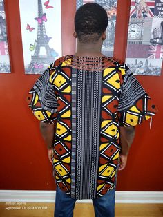 Elevate your wardrobe with our Fulani Dashiki TOP . Made from lightweight wax cotton, the loose fit and embroidered details on the neckline, chest, sleeves, and pocket exude elegance and comfort. Experience the luxury of our Fulani Embroidered pieces. made in Nigeria. Casual Embroidered Short Sleeve Kurta, Traditional Black Cotton Agbada, Traditional Cotton Tunic Kimono, Casual Yellow Long Sleeve Kaftan, Casual Long Sleeve Top With Traditional Patterns, Traditional Short Sleeve Batik Print Kaftan, Traditional Short Sleeve Kaftan With Batik Print, Traditional Brown Cotton Kaftan, Short Sleeve Cotton Kaftan With Relaxed Fit