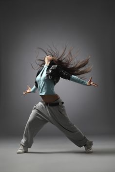 a woman is dancing in the air with her hair flying through the air - stock photo - images