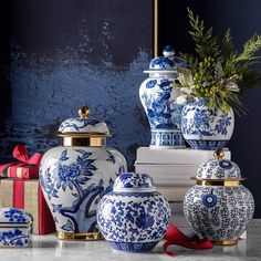 several blue and white vases sitting on top of a table next to each other