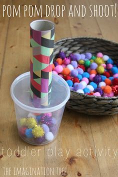 a plastic cup filled with pom - pom balls next to a paper straw