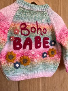 🌺Boho Babe 🌺✌️ This hand embellished, hand knitted cardigan is perfect for your little boho babe. Know anyone going to a festival this summer? This could be a lovely little cardi for them! 🎪🎶 It's knitted in a beautiful rainbow colourway with a comfortable fit and little pink flower buttons This cardigan comfortably fits size 12-18 months, it could even fit up to 2 years. Measurements to follow Handmade Bohemian Spring Cardigan, Handmade Hippie Cardigan For Spring, Handmade Bohemian Sweater For Spring, Bohemian Knitted Cardigan For Festivals, Bohemian Multicolor Embroidered Cardigan, Hippie Crochet Festival Cardigan, Handmade Bohemian Knit Cardigan, Pink Knit Cardigan For The Beach, Bohemian Knitted Beach Sweater