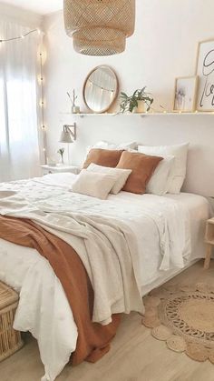 a bedroom with white walls and wooden flooring is decorated in neutral tones, such as beige